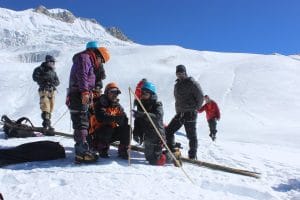 Gunjan Silwal (centre) measuring stake data for glacier mass balance at Yala. Readings on stake measurements help researchers determine whether or not a given year has been a good one for the glacier.