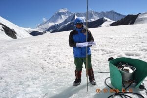 Chyapten Sherpa poses with the stake he helped install on the highest accessible elevation in 2015. (Photo: Tika Gurung/ICIMOD)