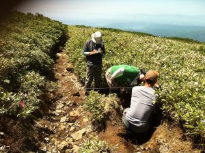 Fig. 3: Tour to measure trail erosion near Asahi-dake The participants also receive lectures by university professors on the erosion process and on basic treatment of the data obtained by a drone (UAV) in the field to understand 3-D trail morphology (Photo: TW)
